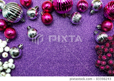 Pink and Silver Christmas balls decoration ornaments with space copy on Purple glitter background Pink and Silver Christmas balls decoration ornaments with space copy on Purple glitter background 83398243