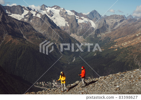 People are engaged in Nordic walking in the mountains. An active couple is engaged in Hiking. A young couple is engaged in tracking. Trekking and Nordic walking. Hiking. Dombay. Copy space People are engaged in Nordic walking in the mountains. An active couple is engaged in Hiking. A young couple is engaged in tracking. Trekking and Nordic walking. Hiking. Dombay. Copy space 83398627