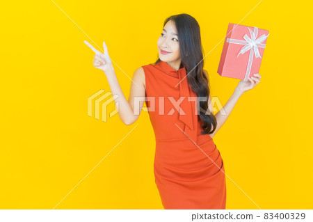 Portrait beautiful young asian woman smile with red gift box Portrait beautiful young asian woman smile with red gift box 83400329