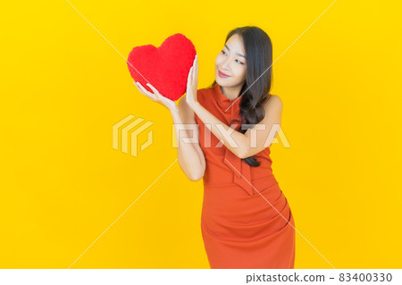 Portrait beautiful young asian woman smile with heart pillow shape Portrait beautiful young asian woman smile with heart pillow shape 83400330