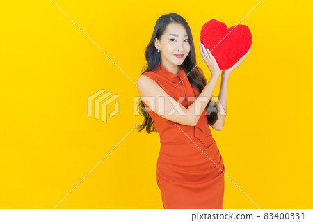 Portrait beautiful young asian woman smile with heart pillow shape Portrait beautiful young asian woman smile with heart pillow shape 83400331