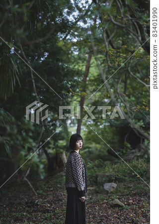 A woman strolling in an autumn natural park A woman strolling in an autumn natural park 83401990