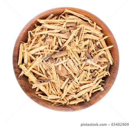 Muira Puama herbal tea in wooden bowl, isolated on white background. Natural potency wood, medicinal plant, dry tea. Ptychopetalum olacoides. Top view. 83402909