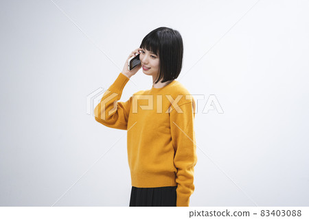 Woman using a smartphone Woman using a smartphone 83403088