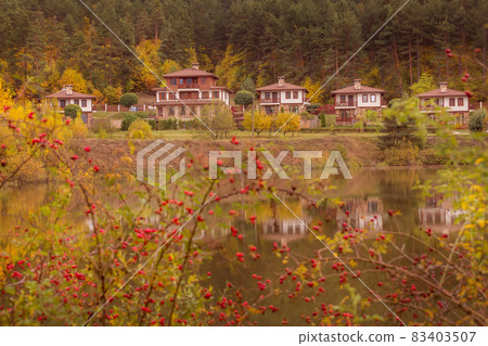 Autumn landscape with lake and houses, Bulgaria 83403507