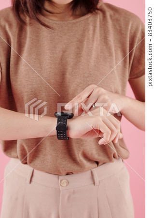 Wwoman Pointing at Smartwatch 83403750