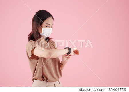 Woman Checking Notifications on Smartwatch Woman Checking Notifications on Smartwatch 83403758