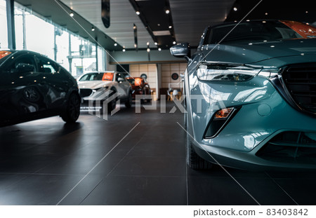 Selective focus grey car parked in luxury showroom. Car dealership office. New car parked in modern showroom. Car for sale and rent business concept. Automobile leasing and insurance background. Selective focus grey car parked in luxury showroom. Car dealership office. New car parked in modern showroom. Car for sale and rent business concept. Automobile leasing and insurance background. 83403842