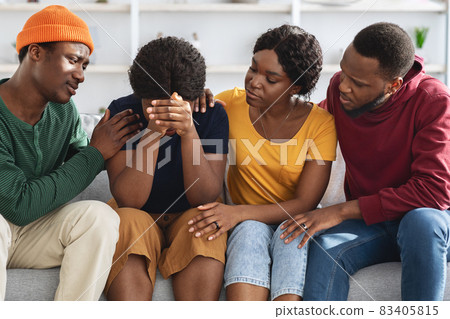 Empathetic black friends supporting upset young lady Empathetic black friends supporting upset young lady 83405815