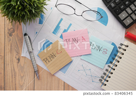 financial graph, calculator and notepad on table financial graph, calculator and notepad on table 83406345