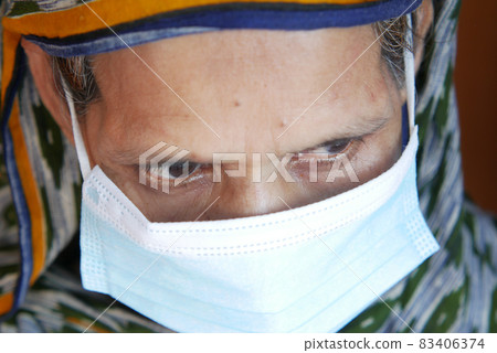 close up of senior asian women's eye with face mask close up of senior asian women's eye with face mask 83406374