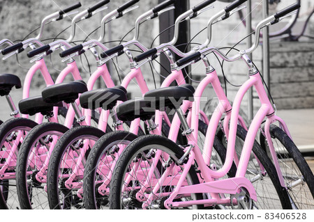 Pink Bicycles in a row ready to rent Pink Bicycles in a row ready to rent 83406528