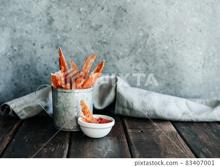 Dried chicken, dried poultry, cut into strips in a metal bucket on a wooden background. Serving a meal in a restaurant Dried chicken, dried poultry, cut into strips in a metal bucket on a wooden background. Serving a meal in a restaurant 83407001