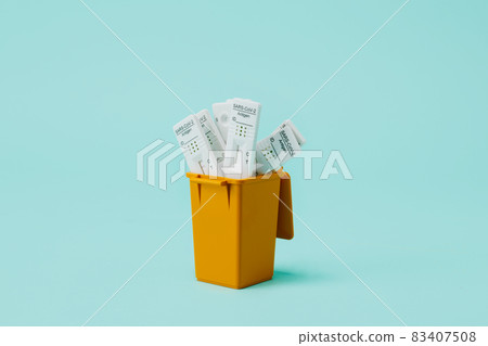 dustbin full of used covid-19 rapid test devices 83407508