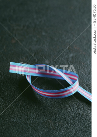 transgender pride flag in a ribbon 83407510