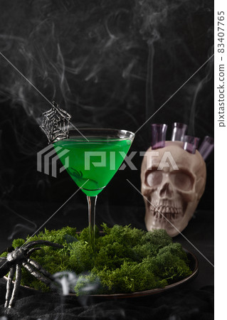 Halloween green cocktails with skulls, spiders and smoke on black Halloween green cocktails with skulls, spiders and smoke on black 83407765