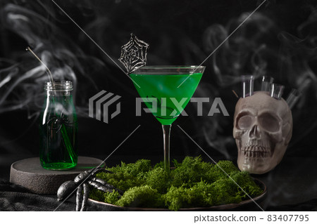 Halloween green cocktails with skulls, spiders and smoke on black Halloween green cocktails with skulls, spiders and smoke on black 83407795
