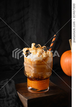 Halloween Pumpkin spice latte coffee with whipped cream decorated skulls . Halloween Pumpkin spice latte coffee with whipped cream decorated skulls . 83407800