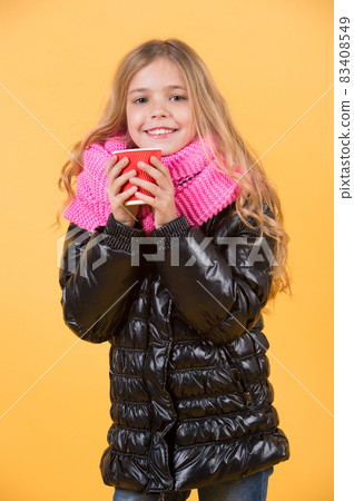 Girl with long blond hair in black jacket hold mug 83408549