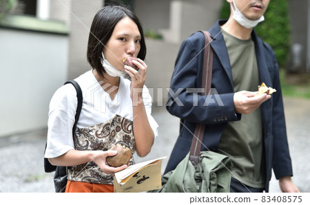 Couple eating roasted sweet potato 3 83408575