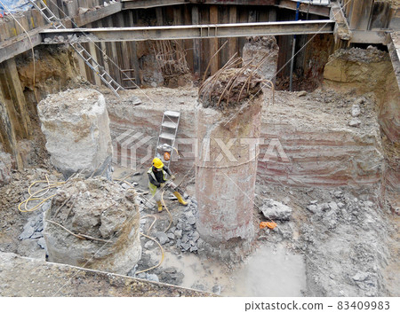 JOHOR, MALAYSIA -JUNE 16, 2015: Excavated bore pile and ready to cut to designated level at the construction site. The bore pile must cut before can fabricate the pile cap. JOHOR, MALAYSIA -JUNE 16, 2015: Excavated bore pile and ready to cut to designated level at the construction site. The bore pile must cut before can fabricate the pile cap. 83409983