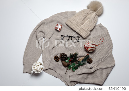 New Year's cozy flatlay composition with a sweater hat and festive decor. Christmas mockup postcard. Background image 83410490