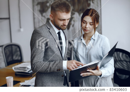 Man and woman read a business contract Man and woman read a business contract 83410603
