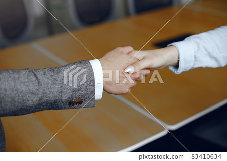 Handshake isolated on business background Handshake isolated on business background 83410634