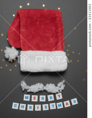 Christmas card with red santa cap and cotton mustache. Flatlay composition Christmas card with red santa cap and cotton mustache. Flatlay composition 83411003