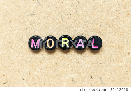 Black color round bead in word moral on wood background 83412968