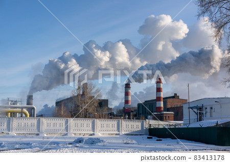 Thermal power plant. Grey smoke comes from the chimney. Pollution of the environment 83413178