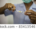 Close-up of doctors, nurses, sucking vaccines from bottles, preparing to vaccinate against and cure from coronavirus, covid-19, flu, infection. Medical concept of vaccination. 83413546
