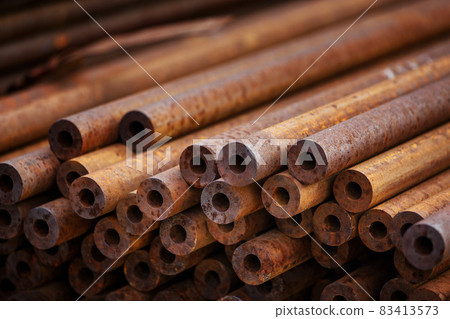 Many small-diameter metal pipes for gasification and construction lie in a stack in an open Many small-diameter metal pipes for gasification and construction lie in a stack in an open 83413573