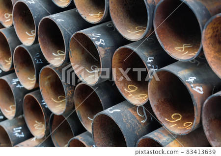 Maetallic pipes of the same diameter are neatly stacked. View of pipes from the front. Background Maetallic pipes of the same diameter are neatly stacked. View of pipes from the front. Background 83413639