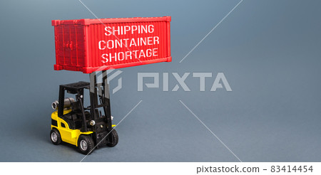 A forklift is loading a container. Container shortage. Inability to export and import products, lack of capacity in the global transport system. World trade imbalance High prices for transportation 83414454