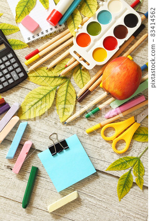 Back to school. Flatlay background. Table with autumn leaves, apple and school supplies. Top view flat lay. Free space for your text. Back to school. Flatlay background. Table with autumn leaves, apple and school supplies. Top view flat lay. Free space for your text. 83414562