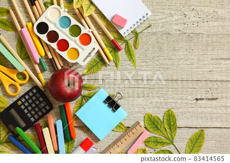 Back to school concept. Flatlay background. Table with autumn leaves and different school supplies, stationery, pencils. Free space for your text. 83414565