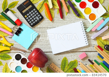 Back to school. Flatlay background. Table with autumn leaves, note pad, apple and school supplies. Free space for your text. Back to school. Flatlay background. Table with autumn leaves, note pad, apple and school supplies. Free space for your text. 83414570
