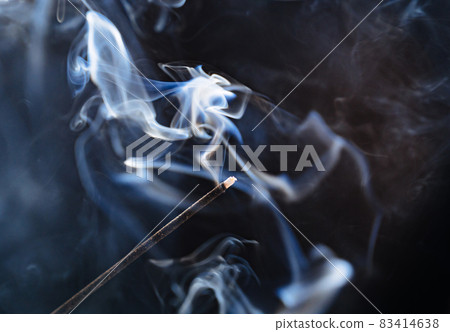 smoke from an aromatic stick on a black background. 83414638