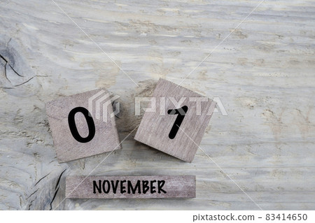 cube calendar for november on wooden background with copy space 83414650