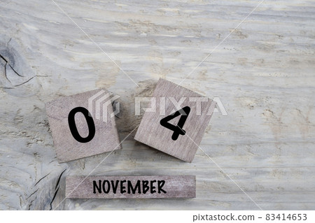 cube calendar for november on wooden background with copy space 83414653