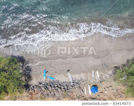 Aerial top view of Launiupoko State Beach with surfer ready to go to the water, Hawaii 83414873