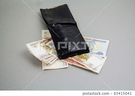 Retro-black wallet and banknotes of 1000 and 100 rubles sticking out of it. Business and finance, the concept of wealth. Crisis Retro-black wallet and banknotes of 1000 and 100 rubles sticking out of it. Business and finance, the concept of wealth. Crisis 83415041