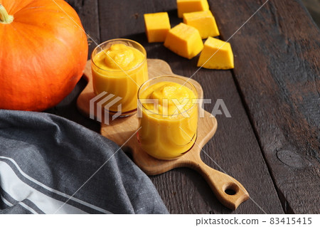 Pumpkin smoothie with spices on a wooden background Top view. Copy space Pumpkin smoothie with spices on a wooden background Top view. Copy space 83415415