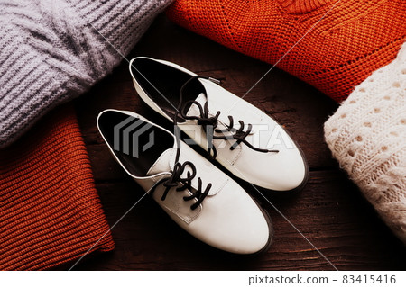 Warm sweaters for winter background. Women\'s stylish clothes. Cozy autumn look. Flat lay, top view. Warm sweaters for winter background. Women\'s stylish clothes. Cozy autumn look. Flat lay, top view. 83415416