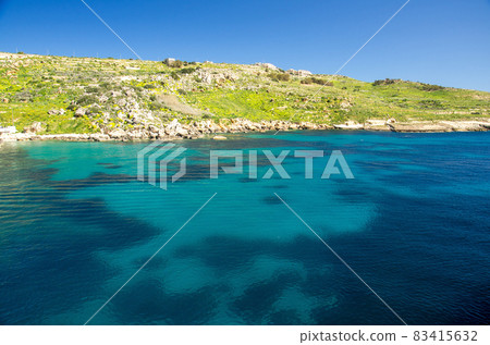 Vivid blue water in harbour near town Mgarr in Gozo island, Malta 83415632