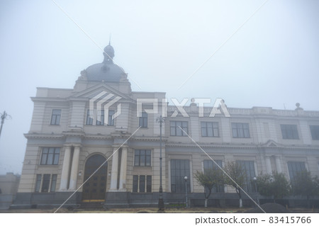 Vintage building of railway station in fog weather 83415766