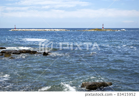 Waves crashing the rocks at Porec beach, Istria, Croatia. Waves crashing the rocks at Porec beach, Istria, Croatia. 83415952