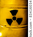Yellow metal barrel with radioactive decay symbol 83416034