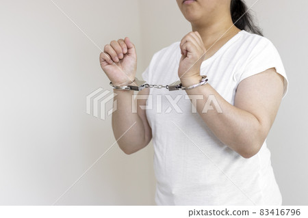 A woman wearing handcuffs (30s, Japanese, no face). Image of arrest 83416796
